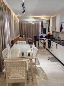 a kitchen and dining room with a table and chairs at Masa villa in Ash Shāghūr +10 photos