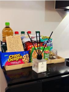 a counter top with snacks and a vase with sticks at Aurora Escalades in Manila