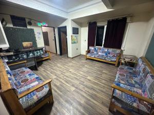 a room with several beds and chairs in it at happy life hostel in Cairo +29 photos