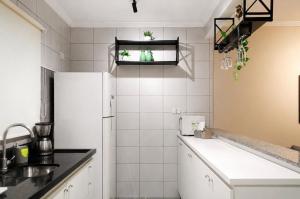 a kitchen with a white refrigerator and a sink at Flórida vivo bem! in São Roque +200 photos