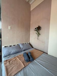 a bed with two blue pillows on it in a room at Maru Vibe Studio unit in San Juan