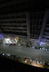 a view of a parking lot at night with cars at happy life hostel in Cairo