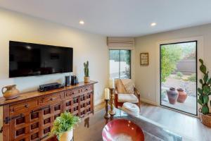 a living room with a flat screen tv on a wall at Adobe Barona Dream in Palm Springs