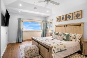 a bedroom with a large bed and a window at Pacific Combo WOcean View Private Patio in Ventura