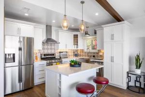 a kitchen with white cabinets and stainless steel appliances at Pacific Combo WOcean View Private Patio in Ventura