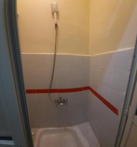 a small bathroom with a shower and a toilet at happy life hostel in Cairo