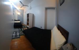 a living room with a couch and a ceiling fan at happy life hostel in Cairo