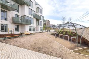 a row of plants in front of a building at Apex Executive Apartments - The Lookout in Dublin