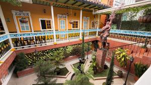 a man standing on the balcony of a house at HotelSueño Dorado Aguadas in Aguadas