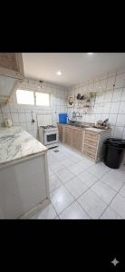 a kitchen with a sink and a stove at Sultana Apartments in Abha