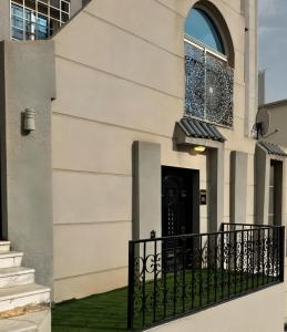 a building with a black door and a window at Sultana Apartments in Abha