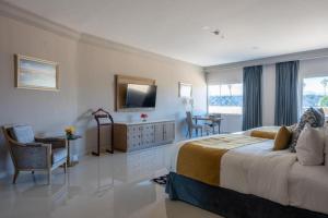 a hotel room with a large bed and a television at Azul Talavera Country Club in Torreón