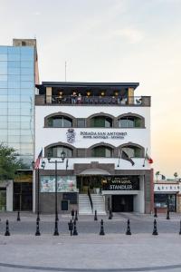 a large white building with a staircase in front of it at Hotel Posada San Antonio in Reynosa