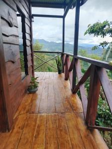 a wooden deck with a view of the mountains at Cielo nocturno Perez Zeledon in Berlín