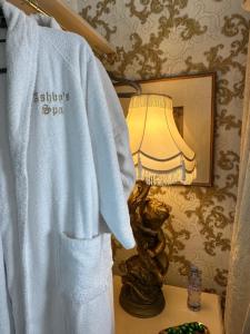 a white robe on a table next to a lamp at Luxury Studios with Spa included in Portsmouth