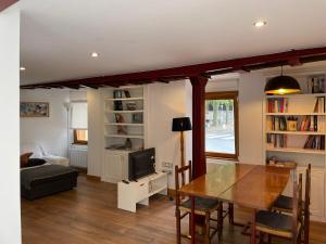 a living room with a dining room table and a couch at Atalaya in Mundaka