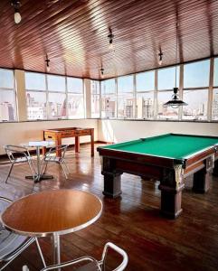 a pool table in a large room with windows at Terrazzo Hotel Campos dos Goytacazes in Campos dos Goytacazes