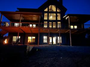 a large house at night with the lights on at Blue Salamander Lodge in Talking Rock