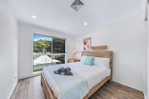a bedroom with a large bed and a window at Blue Lagoon Airlie Beach in Airlie Beach