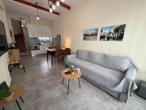 a living room with a couch and a table at 11 Diamond Drive, Luxury Bright & Quiet City Center Loft, Easy Access in Kavála