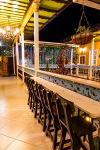 a long wooden table and chairs in a restaurant at HotelSueño Dorado Aguadas in Aguadas