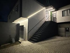 a stairway leading up to a building with a staircase at Studios Botânico in Curitiba +2 photos