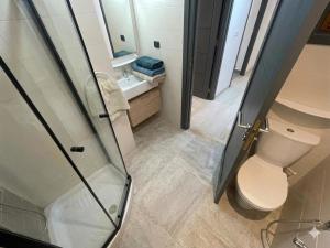 a bathroom with a toilet and a glass shower at S plus 1 in Nabeul