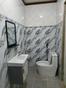 a bathroom with a toilet and a sink at Casa Maria in Sibulan +16 photos