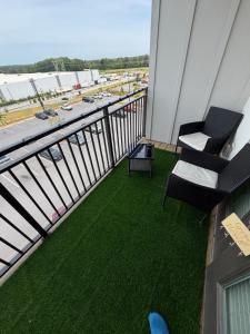 a balcony with two chairs and a view of an airport at Cozy Comfortable Apartment in Atlanta in Atlanta