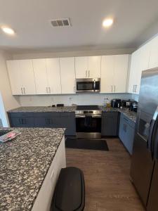 a kitchen with white cabinets and a counter top at Cozy Comfortable Apartment in Atlanta in Atlanta