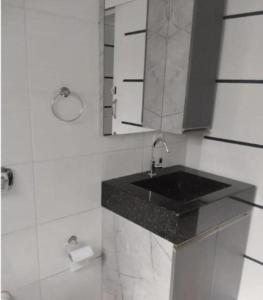 a bathroom with a sink and a mirror at Pousada Hotel Sol Nascente in Mafra +25 photos