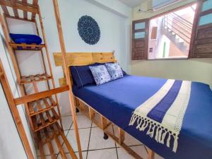 a bedroom with a bunk bed and a ladder at Pousada Mar de Itacaré in Itacaré