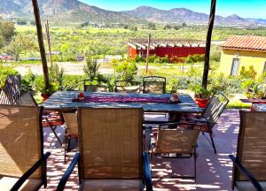 a table and chairs on a patio with mountains in the background at The Bungalow @Terra Monarca in El Porvenir +10 photos