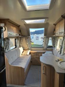 an interior of an rv with two seats and a window at Kościelnik Camp in Kościelnik