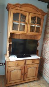 a wooden cabinet with a tv on top of it at Apartamentos Rurales Tauro in Cabezuela del Valle