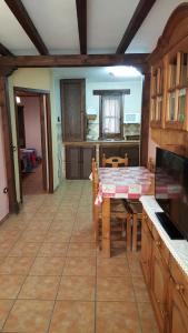 a kitchen with a table and a dining room at Apartamentos Rurales Tauro in Cabezuela del Valle