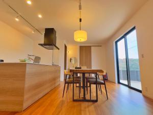 a kitchen and dining room with a table and chairs at Private Villa 蒼 Lala & Lino in Kyotango