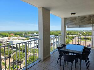 a balcony with a table and chairs and a view at Quest Palmerston - Darwin in Palmerston