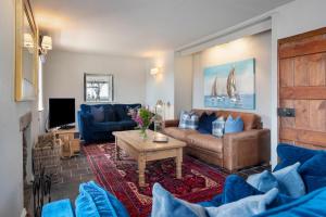 a living room with a couch and a table at 4 Bed in St. Brides oc-o30488 in Saint Brides