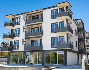 an apartment building with windows and balconies at Nastov Apartments in Veles