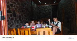 a group of people sitting at a table at A THÁM homestay in Dam Thuy