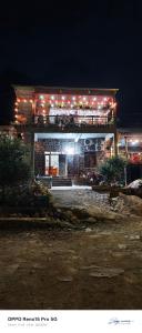 a building with lights on top of it at night at A THÁM homestay in Dam Thuy