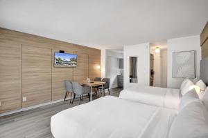 a hotel room with two beds and a table at Ocean Blvd Two Doubles Suite with Kitchenette in Fort Lauderdale +26 photos