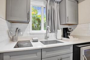 a kitchen counter with a sink and a window at Ocean Blvd Two Doubles Suite with Kitchenette in Fort Lauderdale
