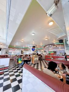 people sitting at tables in a fast food restaurant at Hotel Tiffany - Laoag in Laoag +37 photos