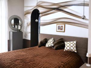 a bedroom with a large bed with pillows on it at Spacious Apartment near Lake Maggiore in Luino
