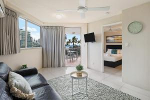 a living room with a couch and a table at Central Mooloolaba Beachfront Apartment - Located in Sandcastles Resort in Mooloolaba