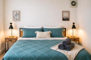 a bedroom with a blue bed with towels on it at The Madison by the Gold Nests in Hollywood