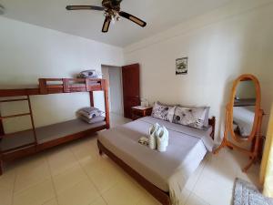 a bedroom with two bunk beds with towels on it at Anton's Beach Resort in Oslob +67 photos