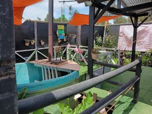 a small boat in a garden with a fence at Mini Regugio in Chillán